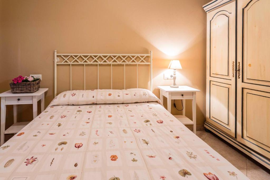 a bedroom with a bed and two night stands at Apartamentos Cotiello in Llanes
