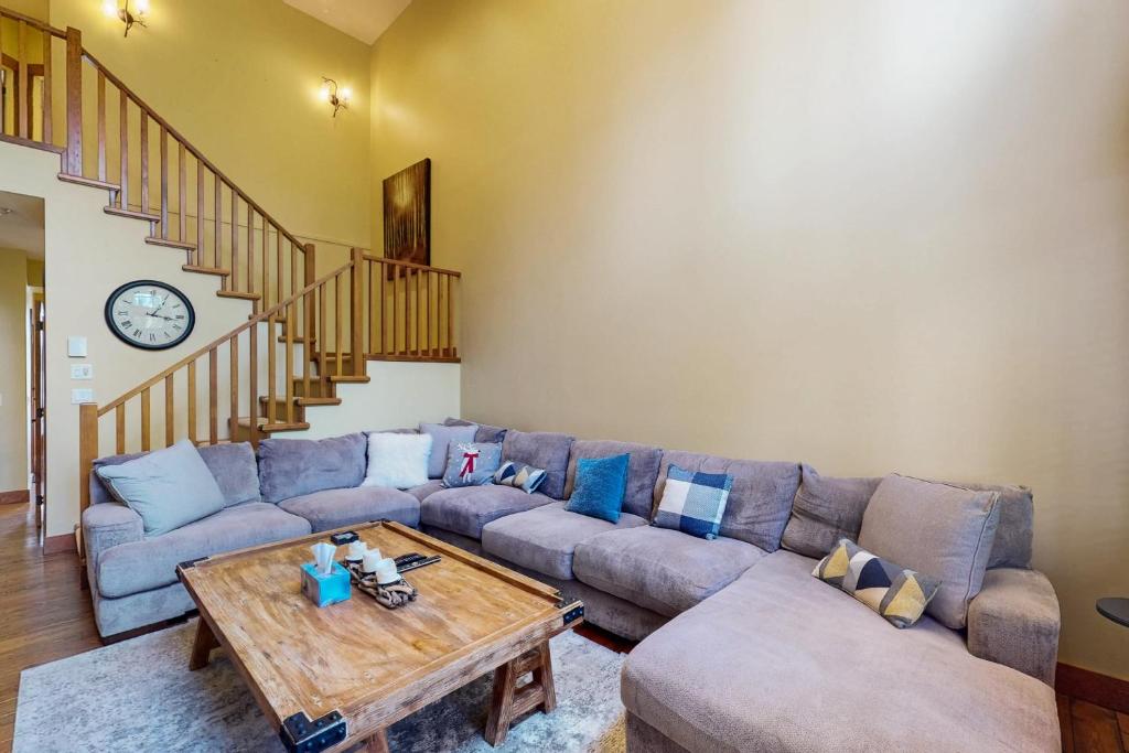 a living room with a couch and a table at Snowbanks 2 in Big White