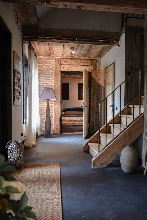 a hallway with stairs and a bed in a room at Boutique Hotel ALTENBURG in Talsi