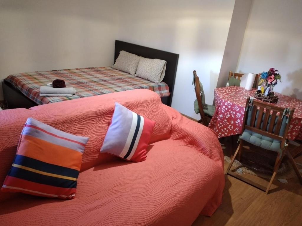 a bedroom with two beds and a chair at Ranjeet felizarda in Lisbon