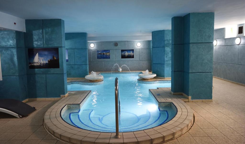 a large swimming pool with two sinks in a building at Topaz Hotel in St Paul's Bay