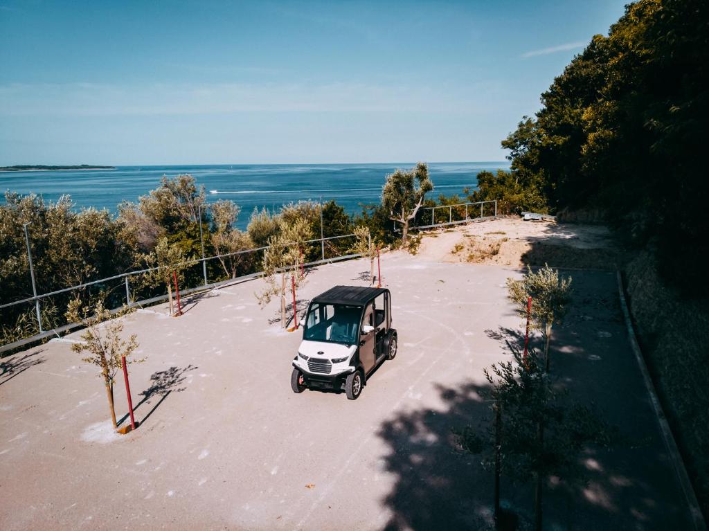 a small white car parked in a parking lot at Second Life in Piran - Hotel Zala Piran in Piran