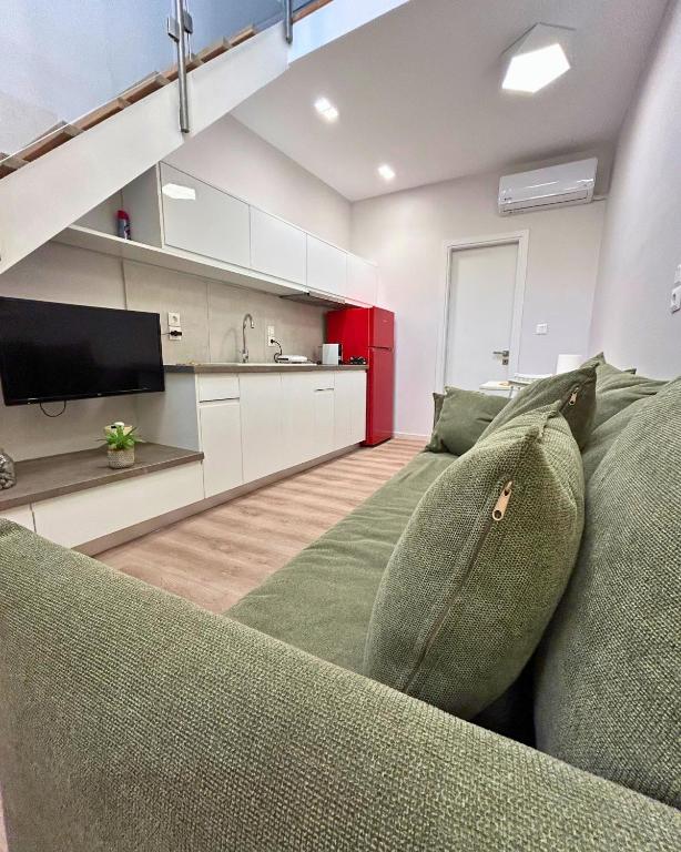 a living room with a couch and a kitchen at Cosy Paradise in Palouki