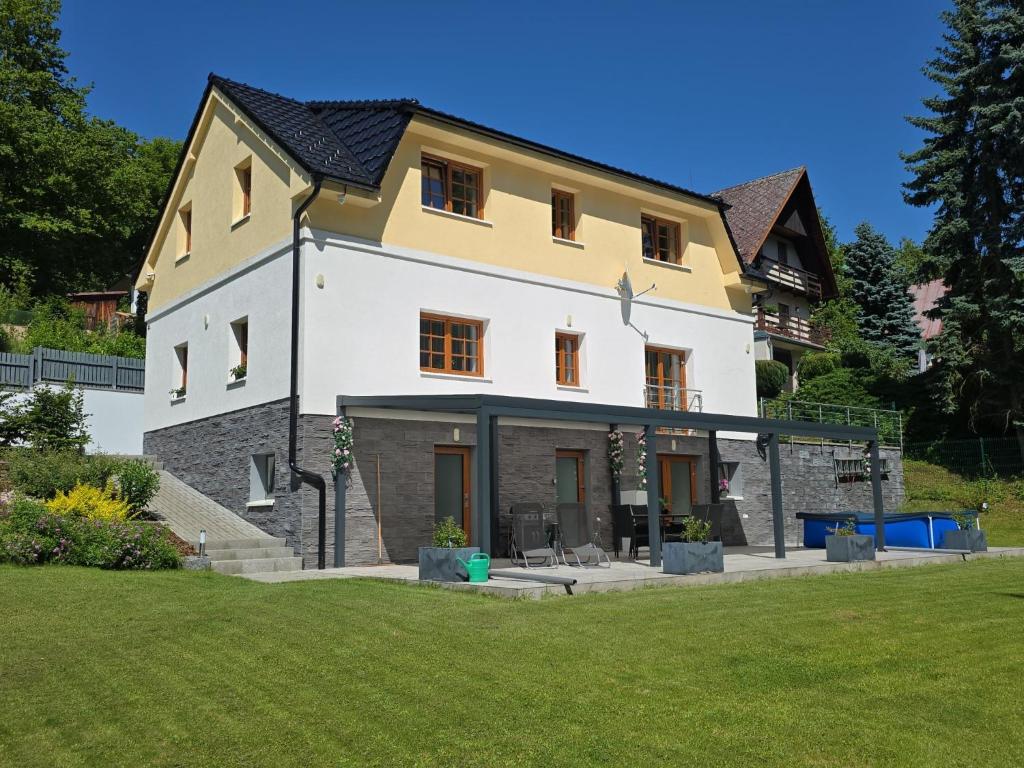 a large white and yellow house with a yard at Holiday Home Posázaví by Interhome in Jílové u Prahy