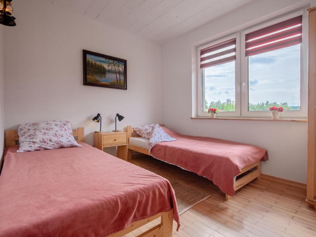 Łóżko lub łóżka w pokoju w obiekcie Holiday Home Zagroda nad Krutynią by Interhome