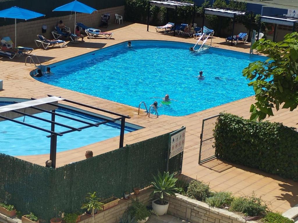 an overhead view of a swimming pool with people in it at Studio Alboran by Interhome in Salou