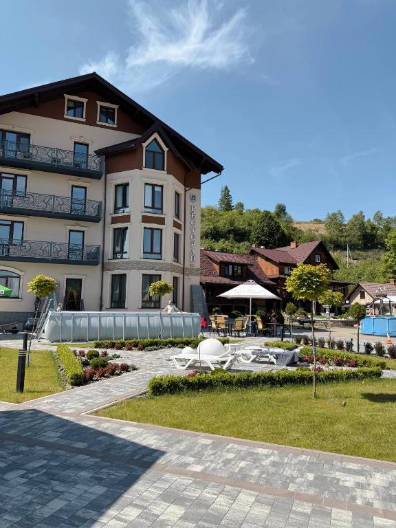 a building with a swimming pool and a resort at Готель-ресторан Два Леви in Slavske