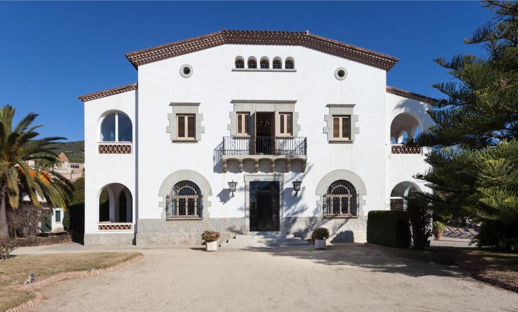 - un bâtiment blanc avec un balcon à l'avant dans l'établissement Villa Maresme, à Cabrils