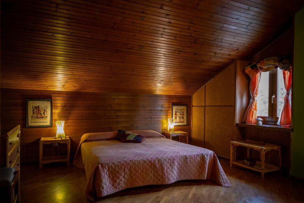 a bedroom with a bed in a wooden room at B&B Pian Savin in Giaveno