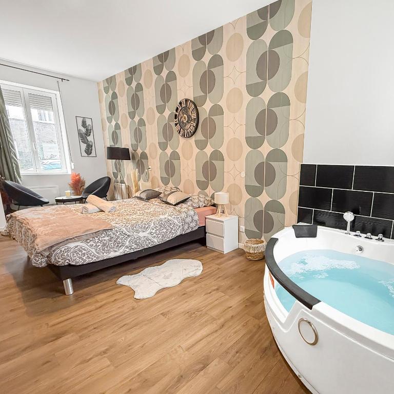 a bedroom with a bed and a bath tub at Jacuzzi privé, terrasse, Roubaix in Roubaix