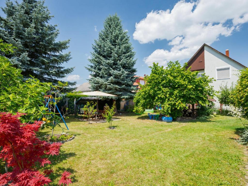 a yard with trees and a house at Apartment Noisette by Interhome in Balatonkeresztúr