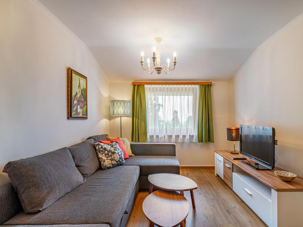 a living room with a couch and a tv at Apartment Simonhöhe-1 by Interhome in Sankt Paul