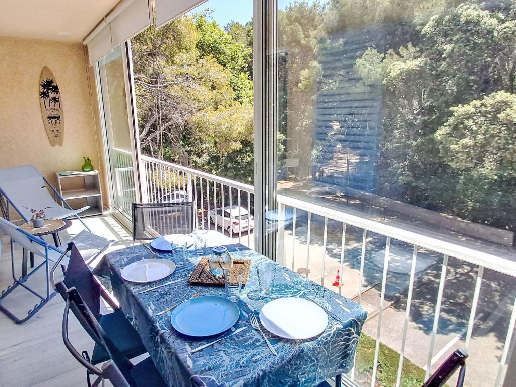 d'une table sur un balcon avec une grande fenêtre. dans l'établissement Apartment le Verdon-5 by Interhome, à Six-Fours-les-Plages