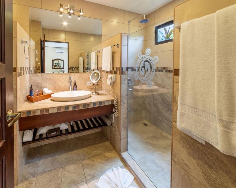 a bathroom with a sink and a shower at Hotel & Spa Poco a Poco - Costa Rica in Monteverde Costa Rica