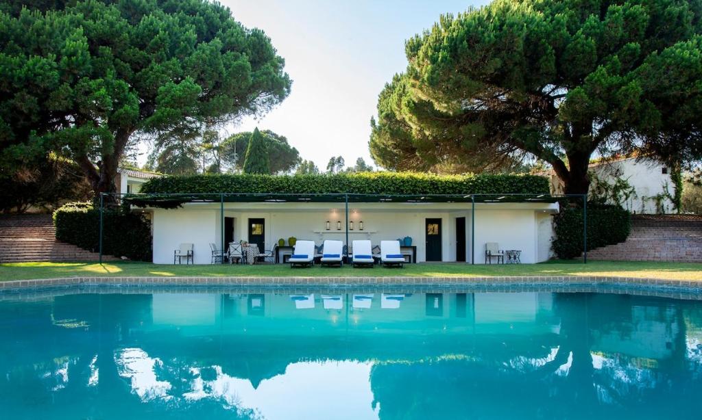 a house with a pool in front of it at To live happily live outside surrounded by nature in Estoril