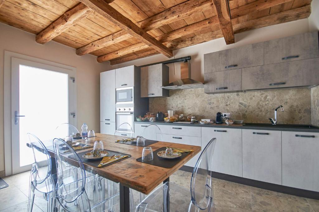 a kitchen with a wooden table and chairs at Da Brussio 