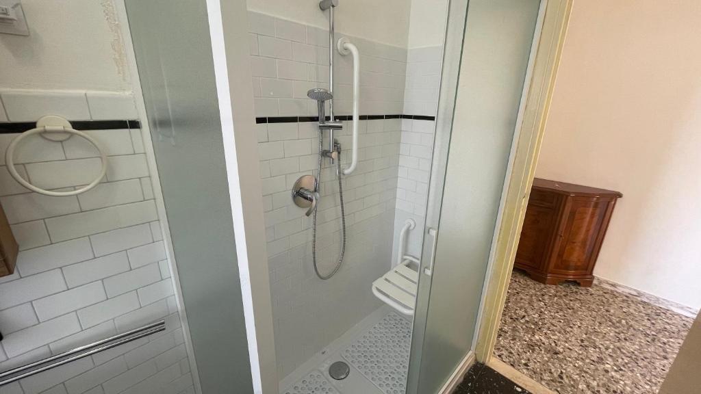a shower with a glass door in a bathroom at Cleo Calla in Ancona