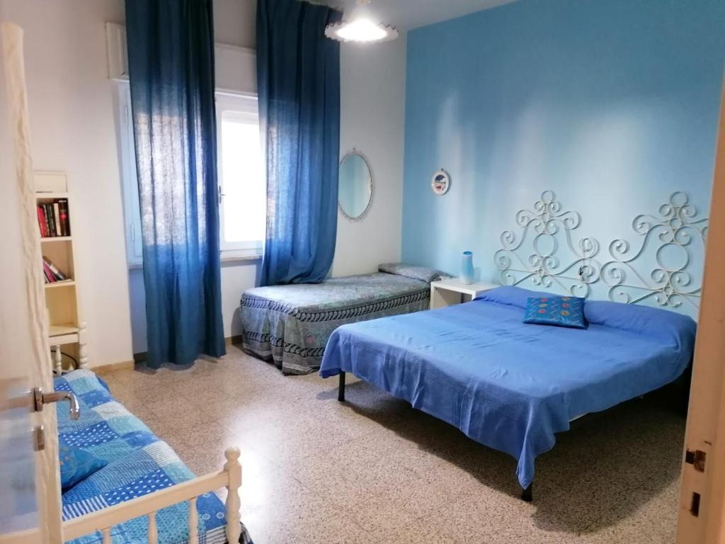 Giường trong phòng chung tại Casa Il Tulipano