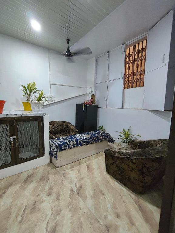 a living room with a couch and a tv at D'Yogi Rooms & Dormitory in Varanasi