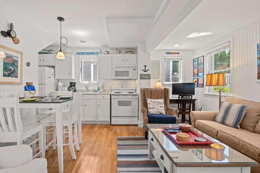 a kitchen and living room with a couch and a table at Private Deck Parking Walk to Town in Provincetown