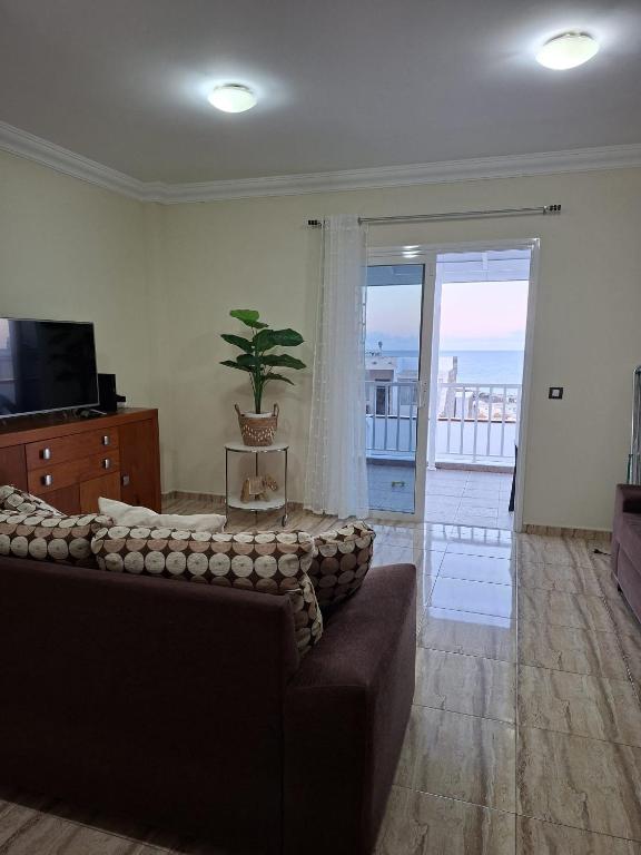 a living room with a couch and a television at Casa Beby in Candelaria