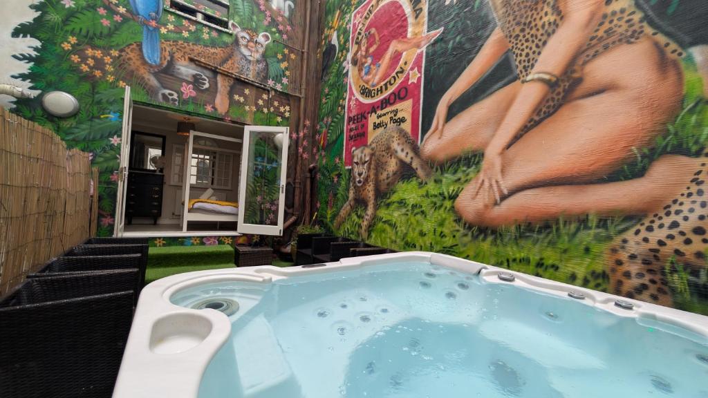 a bathroom with a jacuzzi tub with a mural at The Brighton Parlour with Hot Tub in Brighton & Hove