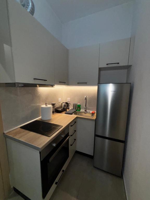 a kitchen with a stainless steel refrigerator and a sink at FanLex Summer House in Nea Kalikratia