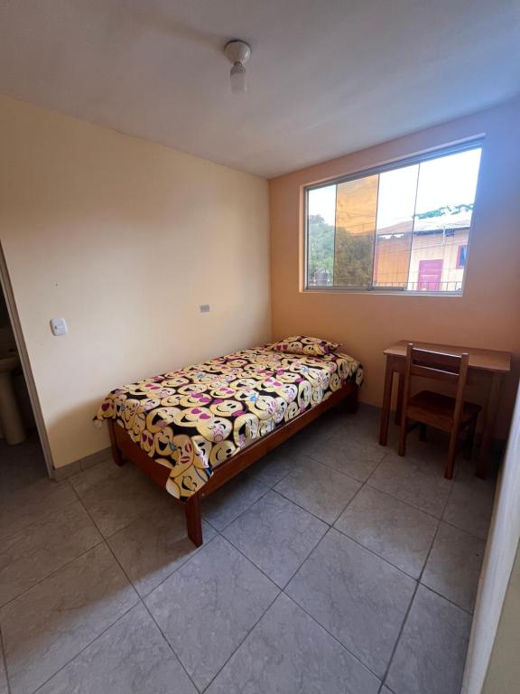 a bedroom with a bed and a table and a window at Zzi in Lamas