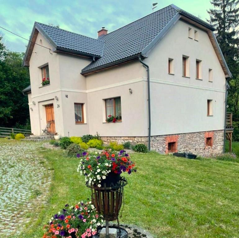 a house with a basket of flowers in front of it at Villa Austeria in Lesica