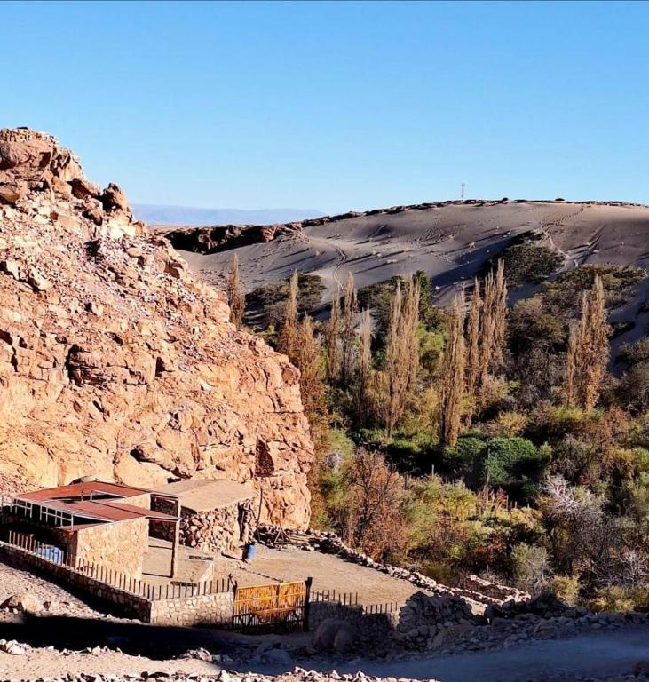 a building on the side of a rocky mountain at Alto Jere in Toconao