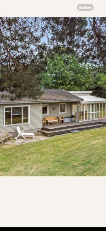 two pictures of a house with a yard at Bøtøstrand feriehus 90 in Marielyst