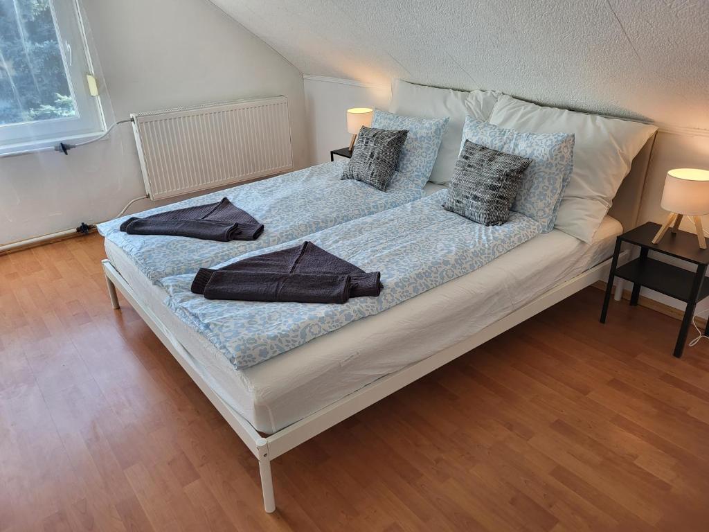 a large bed with pillows on it in a room at Vitorlásház in Balatonvilágos