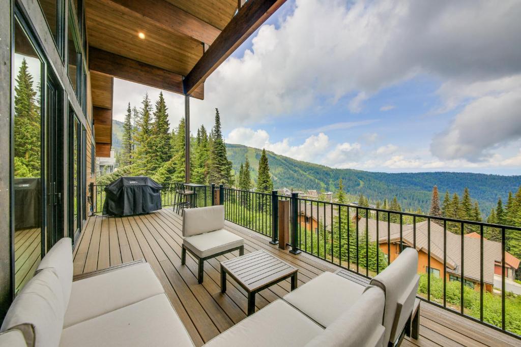 a balcony with white furniture and a view of a mountain at Ski-InandSki-Out Schweitzer Mtn Home Decks and Views! in Sandpoint