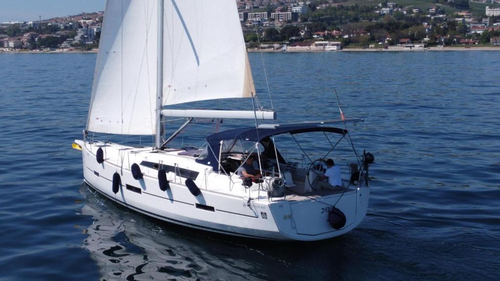 a white sail boat on a body of water at Adriatic Blue Voyage in Tivat