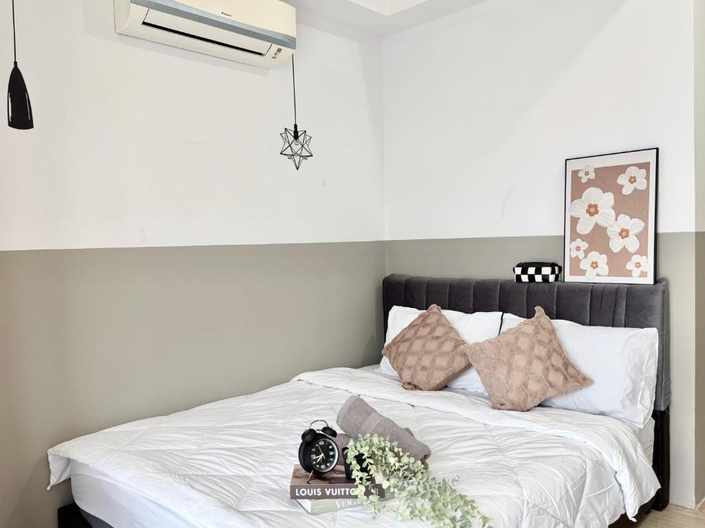 a bedroom with a bed with white sheets and pillows at Pavilion 2 Revol Sky Pool 2-3 pax LS25 in Kuala Lumpur