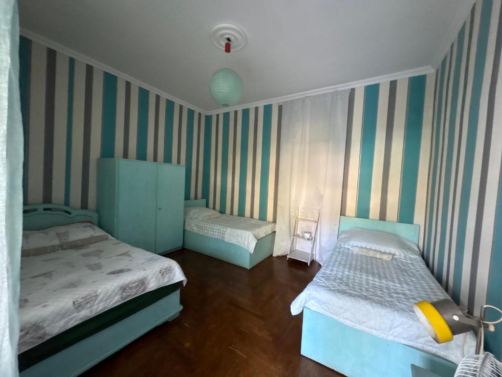 Postel nebo postele na pokoji v ubytování Green House in Batumi