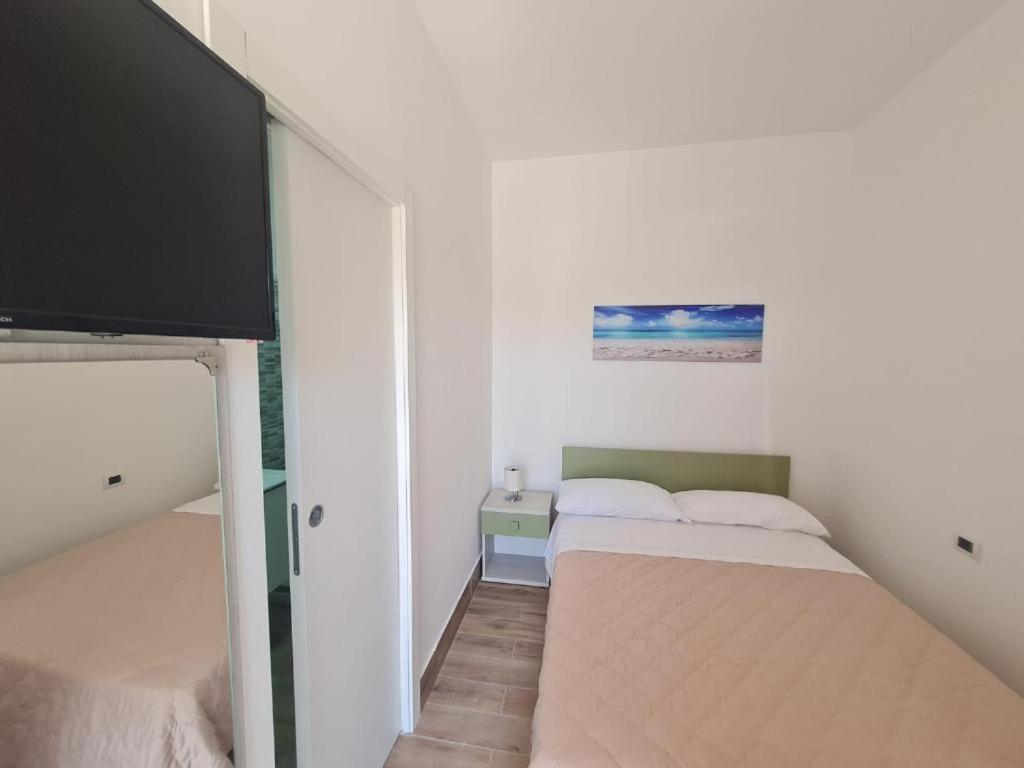 Postel nebo postele na pokoji v ubytování Scauri Rooms B&B