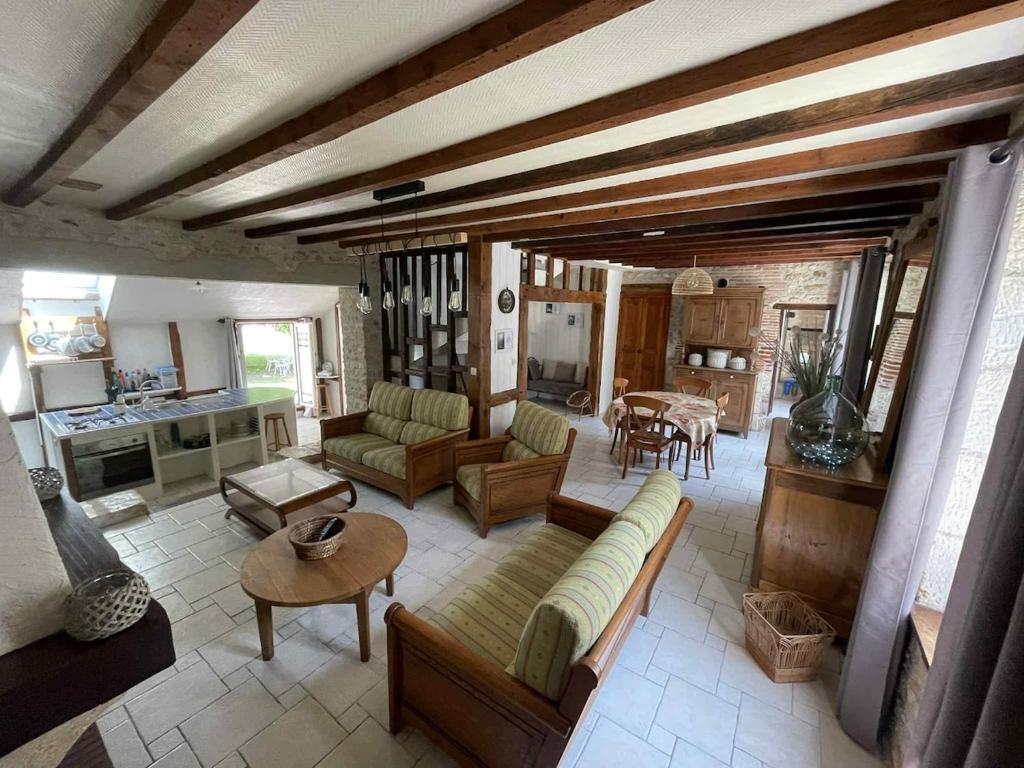 a living room with a couch and a table at Country House in Pruniers