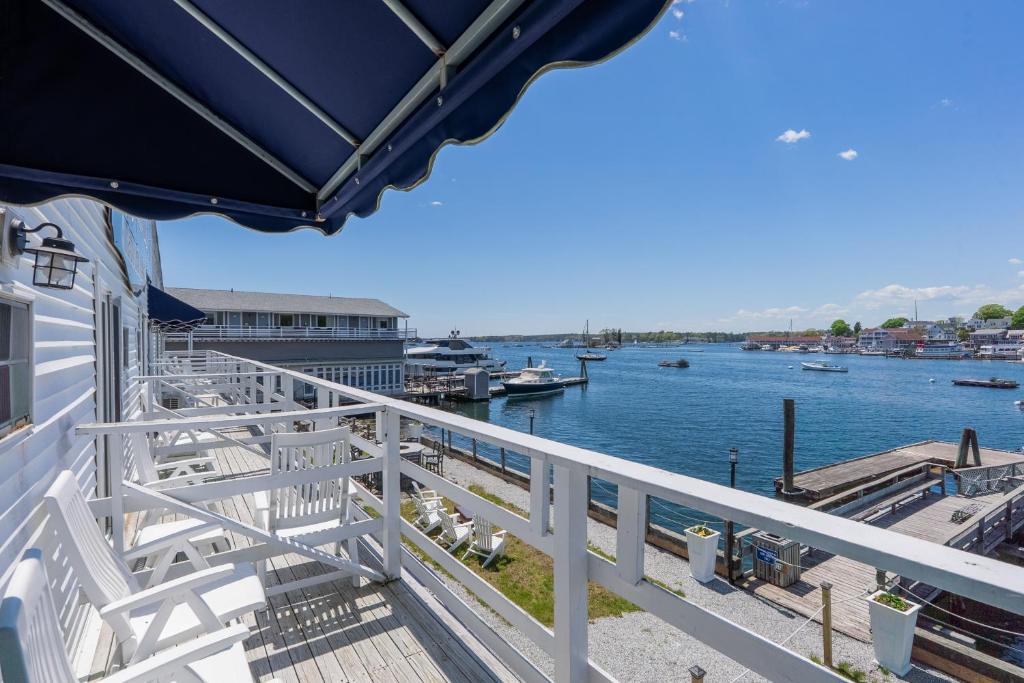 a balcony with a view of the water at Boothbay Harbor Inn in Boothbay Harbor