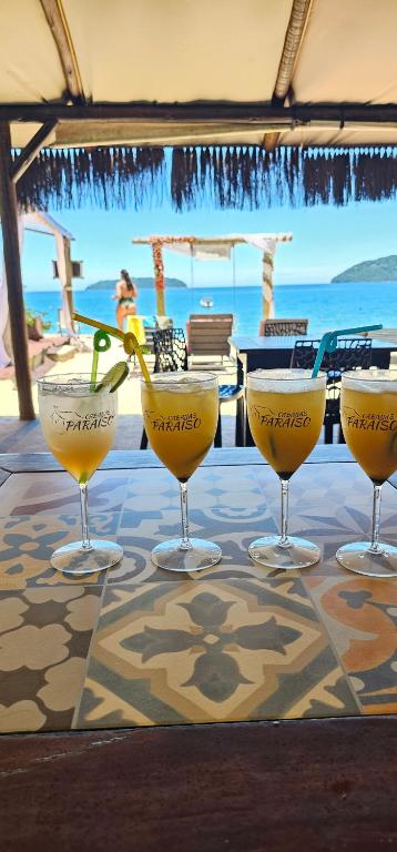 a group of four wine glasses sitting on a table at Pousada Cabanas Paraiso in Angra dos Reis