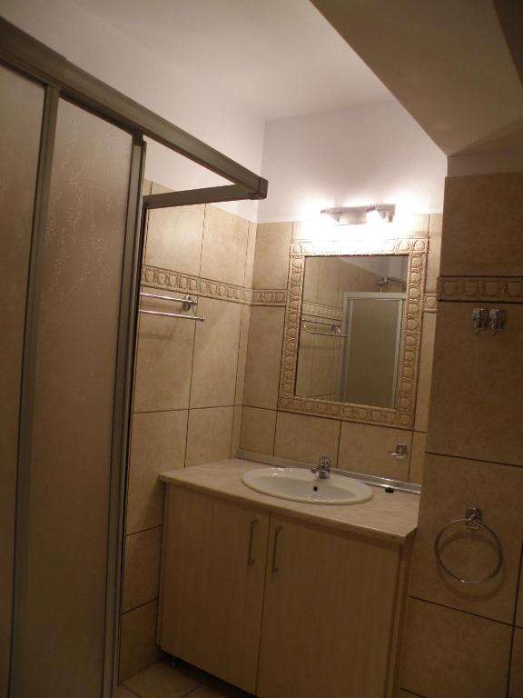 a bathroom with a sink and a mirror at Kate Apartments in Kokkari