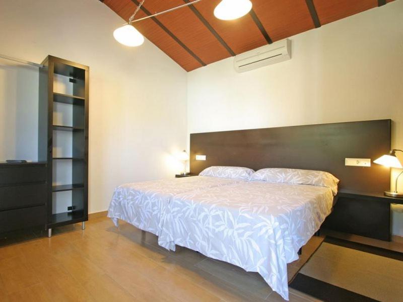 a bedroom with a large bed in a room at Hotel El Paso in Vejer de la Frontera