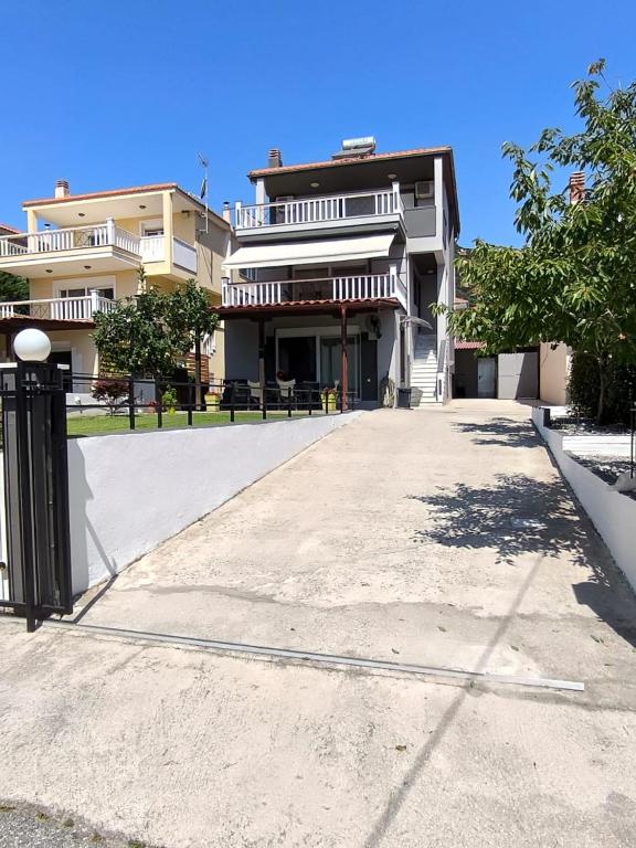 an empty parking lot in front of a building at Fotis Resort in Iraklitsa