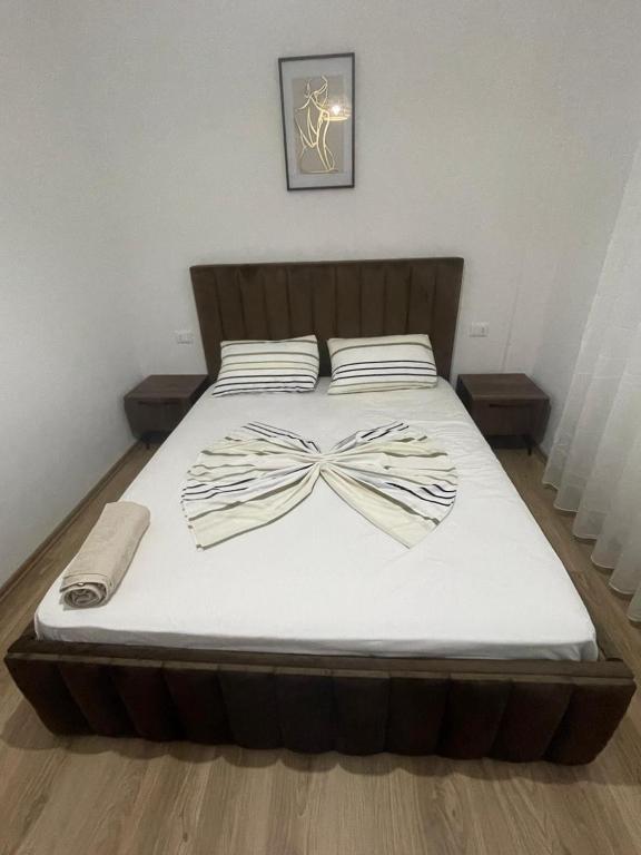 a bed with a bow on top of it at Seliano Residence in Velipojë