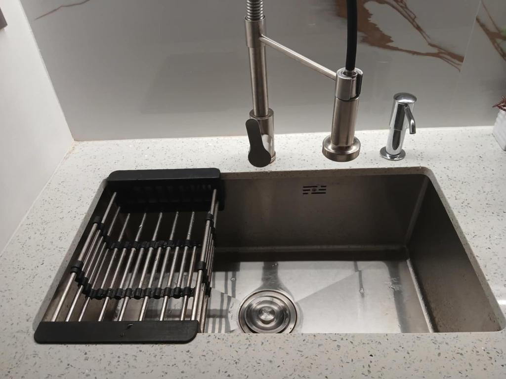 a kitchen sink with a faucet on a counter at MD Suite by Seawind in Davao City