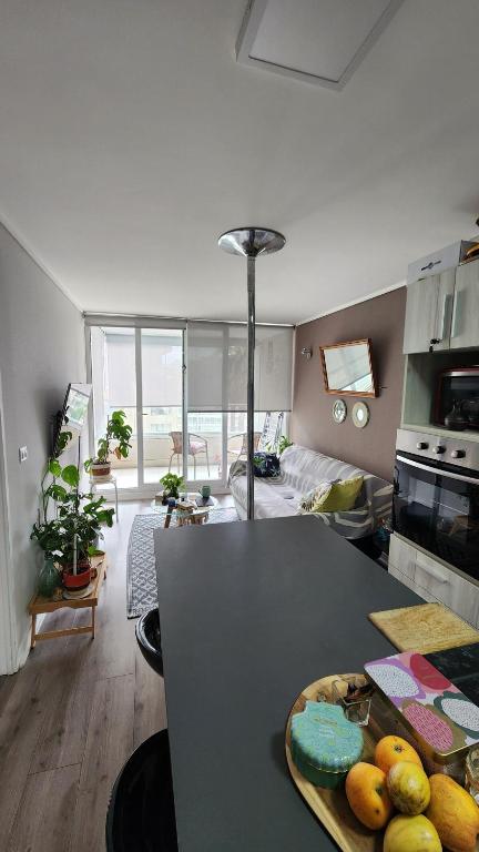 a kitchen with a table with a plate of fruit on it at Cozy and nice apartment in Viña del Mar