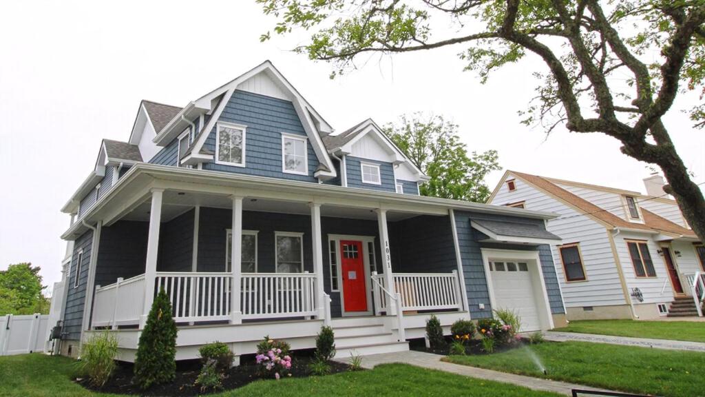 una casa azul con una puerta roja en Coastal Blu W Pool, en Cape May