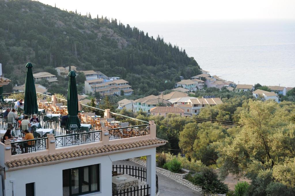 a large building with a mountain range on top of it at Santa Marina Hotel in Agios Nikitas