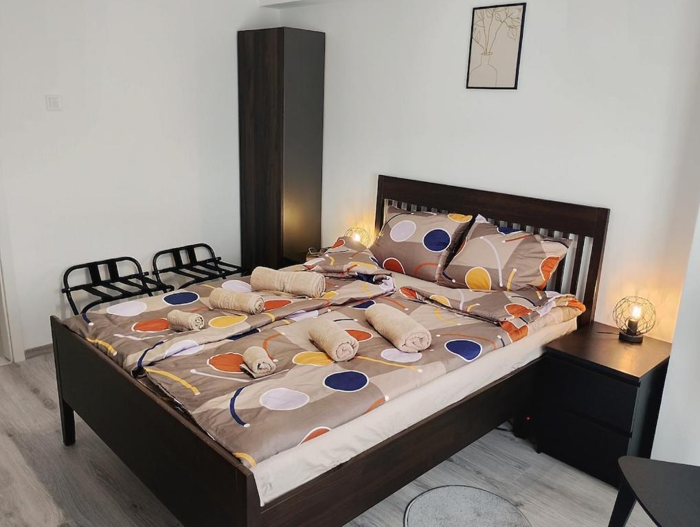 a bed with many pillows on it in a bedroom at Bucarest old center in Văleni