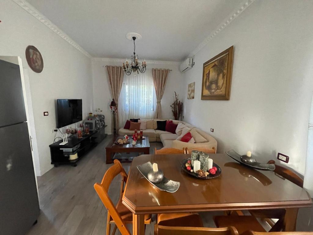 a living room with a table and a couch at Klarisa Beach Apartment in Golem